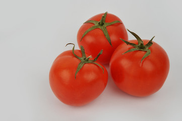 Fresh tomatoes isolated on the gray background