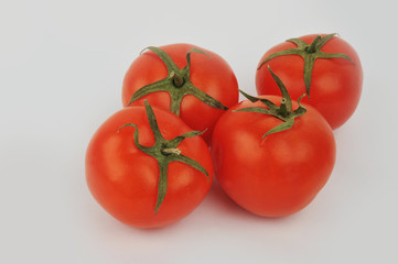 Fresh tomatoes isolated on the gray background