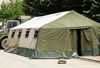 Military tent and truck outdoors © majorosl66