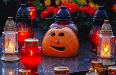 Warsaw, Poland - November 1, 2008: Candles and pumpkin on a grave in Wola Cemetery in Warsaw city...