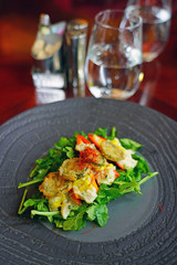 Fried pepper slices on arugula salad