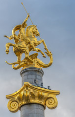 Fototapeta na wymiar Gilded Saint George statue on Freedom Monument in Tbilisi