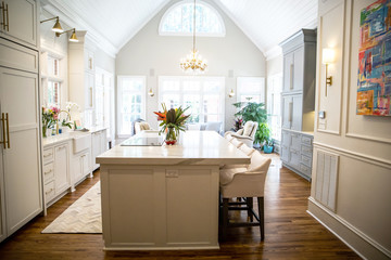 Open Concept Elegant and Spacious Kitchen with Marble Countertops, Chandelier, and Two Toned...