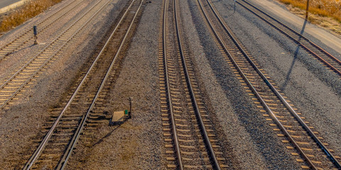 Panorama Railroad tracks and roads with mountain and vibrant cloudy blue sky background