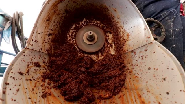Front view of a Grinder in action. Woman making Mole in Puebla Mexico. North America.  Grinding some ingredients. Cooking Traditional recipe.