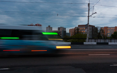 Motion blurred minibus on the overpass road in the evening.