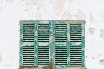 window locked with old green wooden shutters