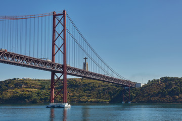 Obraz premium The 25 April bridge (Ponte 25 de Abril) is a steel suspension bridge located in Lisbon, Portugal, crossing the Tagus river. It is one of the most famous landmarks of the region