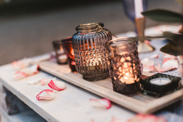 decorative candle lights on served romantic dinner table