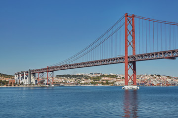Fototapeta na wymiar The 25 April bridge (Ponte 25 de Abril) is a steel suspension bridge located in Lisbon, Portugal, crossing the Tagus river. It is one of the most famous landmarks of the region