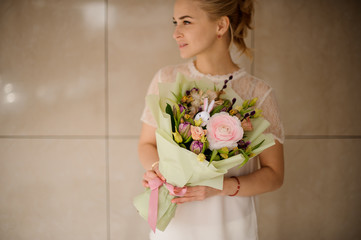 Cute girl in white blouse with bouquet