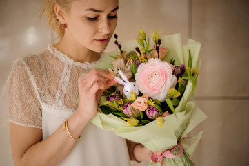 Beautiful girl in white blouse with bouquet