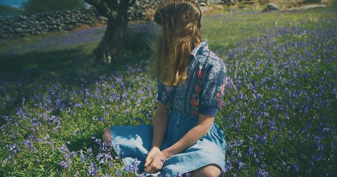 Young woman sitting in meadow