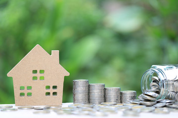 Finance, Stack of coins money and Model house on natural green background, Business investment and...