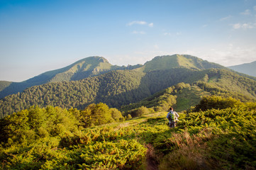 Golden sunset hour in the mountain with hikers on path in adventure