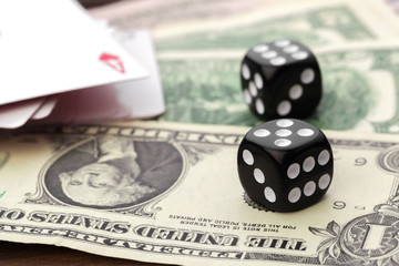 Playing Dices and Stack of American Dollars Bills.
