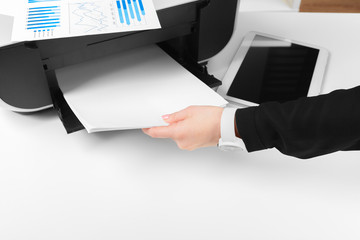 Woman using the printer to scanning and printing document