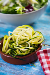 grated zucchini and a mix of leaf vegetables