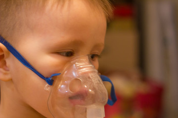 Blurred photo. Child asthma inhaler inhalation nebulizer steam sick cough concept. Medical...
