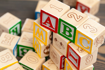 Alphabet blocks ABC on wooden table.