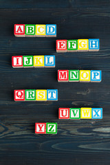 Alphabet blocks ABC on wooden table.