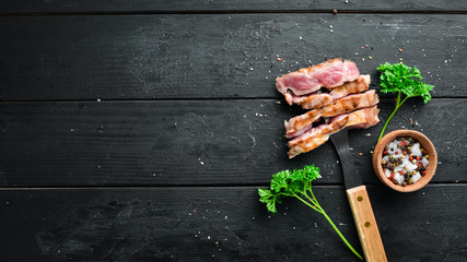 Grilled steak of pork on a fork, chopped with spices and herbs. Top view. Free space for your text.