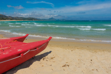 Fototapeta na wymiar Red Paddle Boat on Sardinia Beach