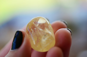 Tumbled Citrine being held in woman's hand. Healing crystal citrine, great for positive thinking....