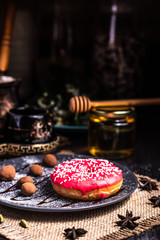 Donut in icing with nuts in a chocolate truffle in a restaurant.