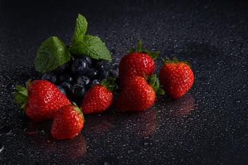 Fruits on black background smoothie ware