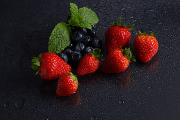 Fruits on black background smoothie ware