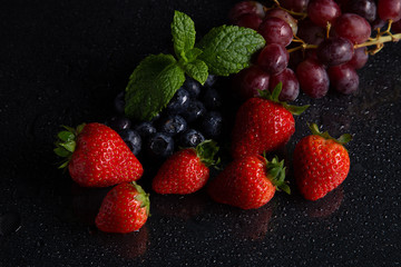 Fruits on black background smoothie ware
