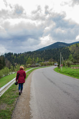 beautiful landscape, girl walking along a mountain road