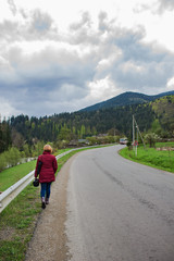 Obraz premium beautiful landscape, girl walking along a mountain road