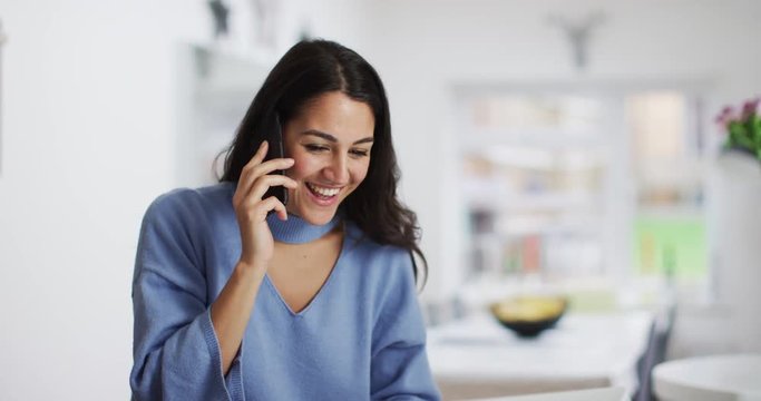 4K Smiling professional woman making a friendly phone call, could be talking to a business contact or a friend. Slow motion.