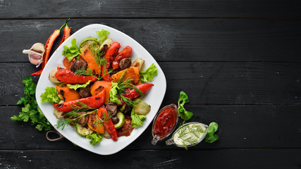 Salad with grilled vegetables. Top view. Free space for your text. Rustic style.