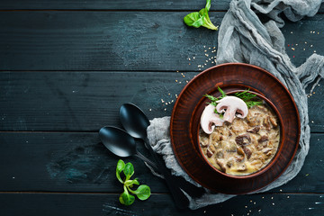 Banosh with mushrooms and bacon. Ukrainian cuisine. Top view. Free space for your text. Rustic style.