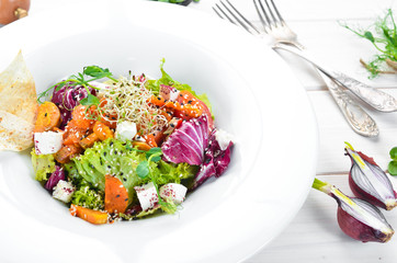 Vegetable salad with cabbage with feta cheese. In the plate. Top view. Free space for your text. Rustic style.