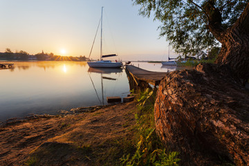 Idyllic sunrise landscape of Powidz Lake in Poland.