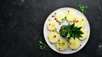Sliced pineapple in a plate. Top view. Free space for your text.