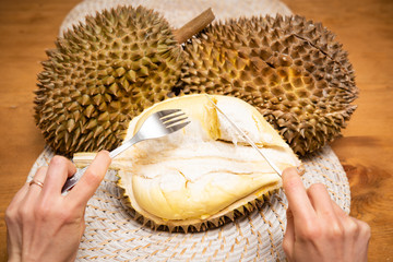 ドリアンを食べようとする女性の手元