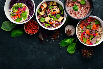 Food with delivery. A set of dishes for the diet. Top view. Free space for your text. On a black background.