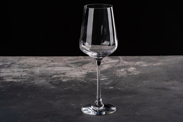 Empty glass of wine on black background