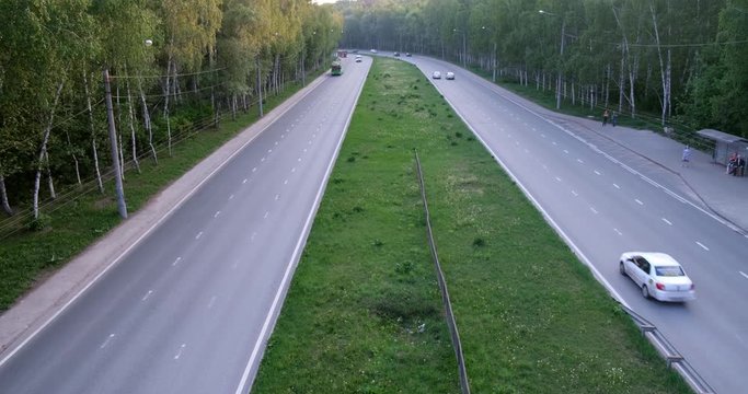 chasse through the forest top view. high-speed passing cars on a wide road, car traffic