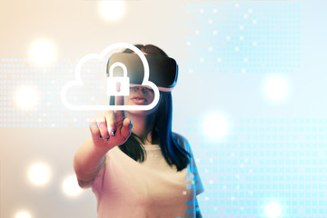young woman in virtual reality headset pointing with finger at internet security illustration on beige and blue background