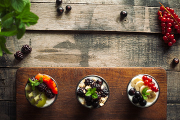 Proteic greek yogurts with fruits: banana, berries, kiwi