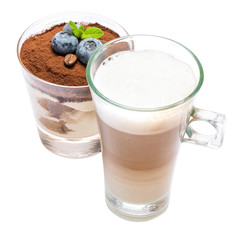 Classic tiramisu dessert with blueberries in a glass and cup of coffee isolated on a white background with clipping path
