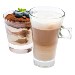 Classic tiramisu dessert with blueberries in a glass and cup of coffee isolated on a white background with clipping path