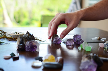 Beautiful Clear Quartz, variety of crystal on wood table. Bright Quartz crystal, healing crystal...