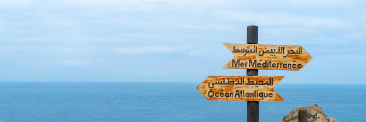 Signs indicating the place where the Atlantic ocean joins the Mediterranean sea near Tangier,...